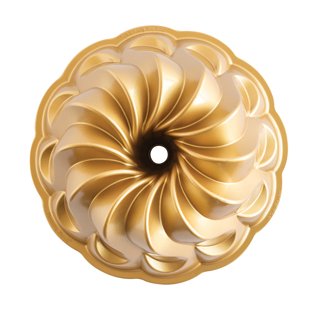 Nordic Ware aluminum Pirouette Bundt pan with elegant spiral fluted design, silver finish, overhead view