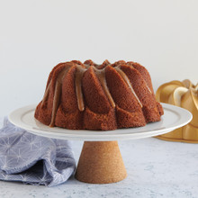 Golden bundt cake with spiral ridged design from Nordic Ware Pirouette pan, topped with caramel drizzle