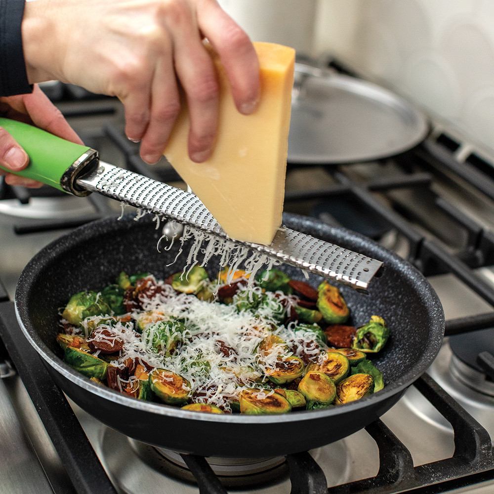 Nordic Ware Basalt ceramic nonstick 10-inch skillet with sautéed Brussels sprouts topped with grated cheese
