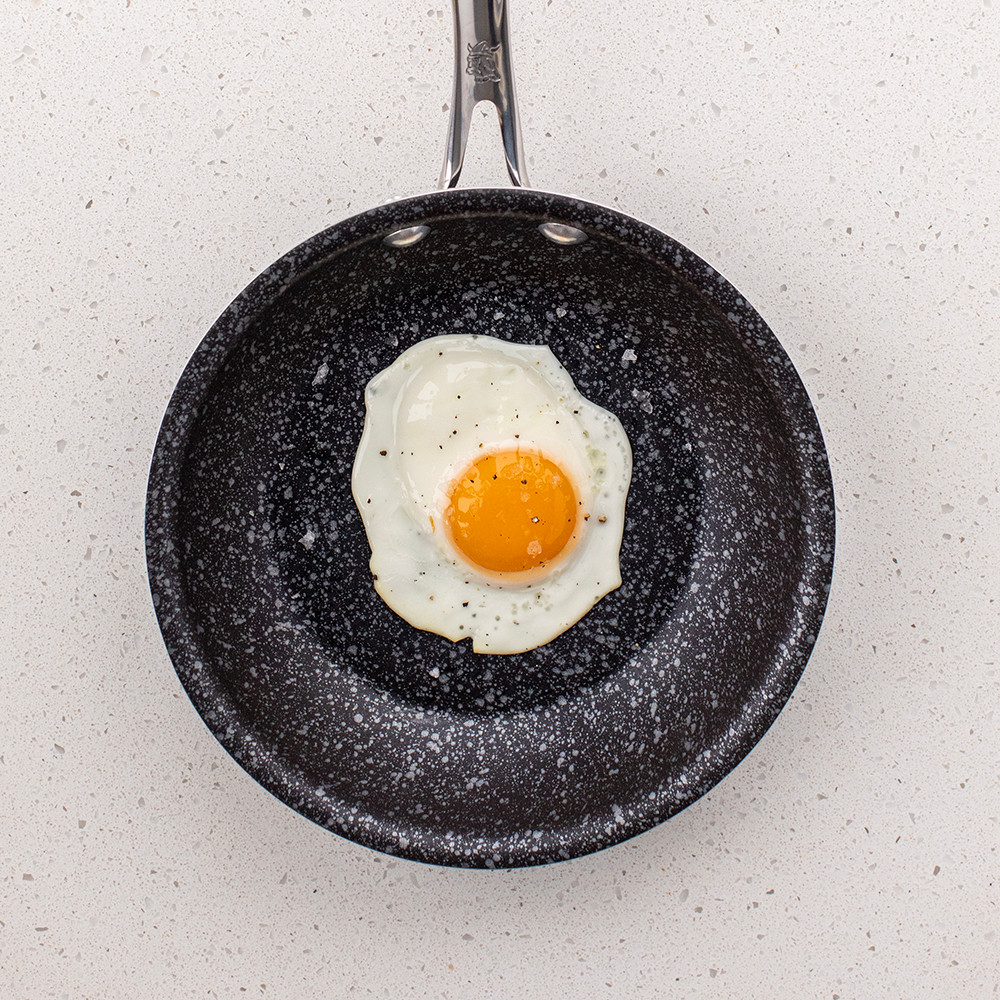 Nordic Ware Basalt ceramic nonstick 8-inch skillet with cooked sunny-side up egg, dark gray finish