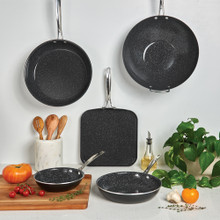 Nordic Ware Basalt 5-piece black non-stick cookware set with skillets and saucepans on marble countertop
