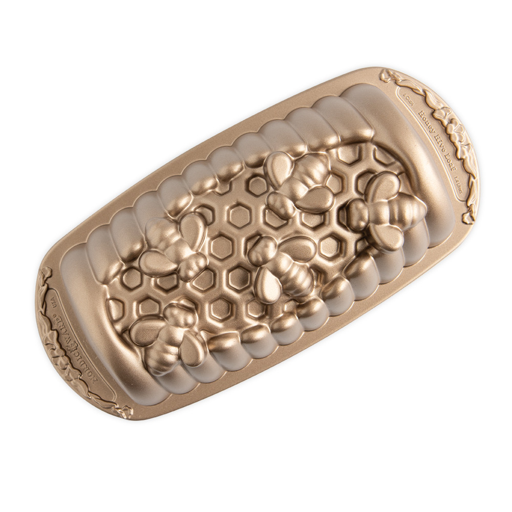 Nordic Ware aluminum honey hive loaf pan with hexagonal honeycomb pattern, natural silver finish