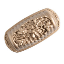 Nordic Ware aluminum honey hive loaf pan with hexagonal honeycomb pattern, natural silver finish