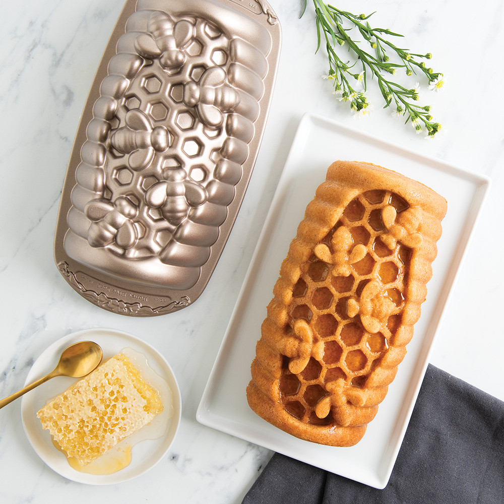 Golden honey-colored loaf cake with hexagonal honeycomb pattern baked in Nordic Ware aluminum Honey Hive loaf pan