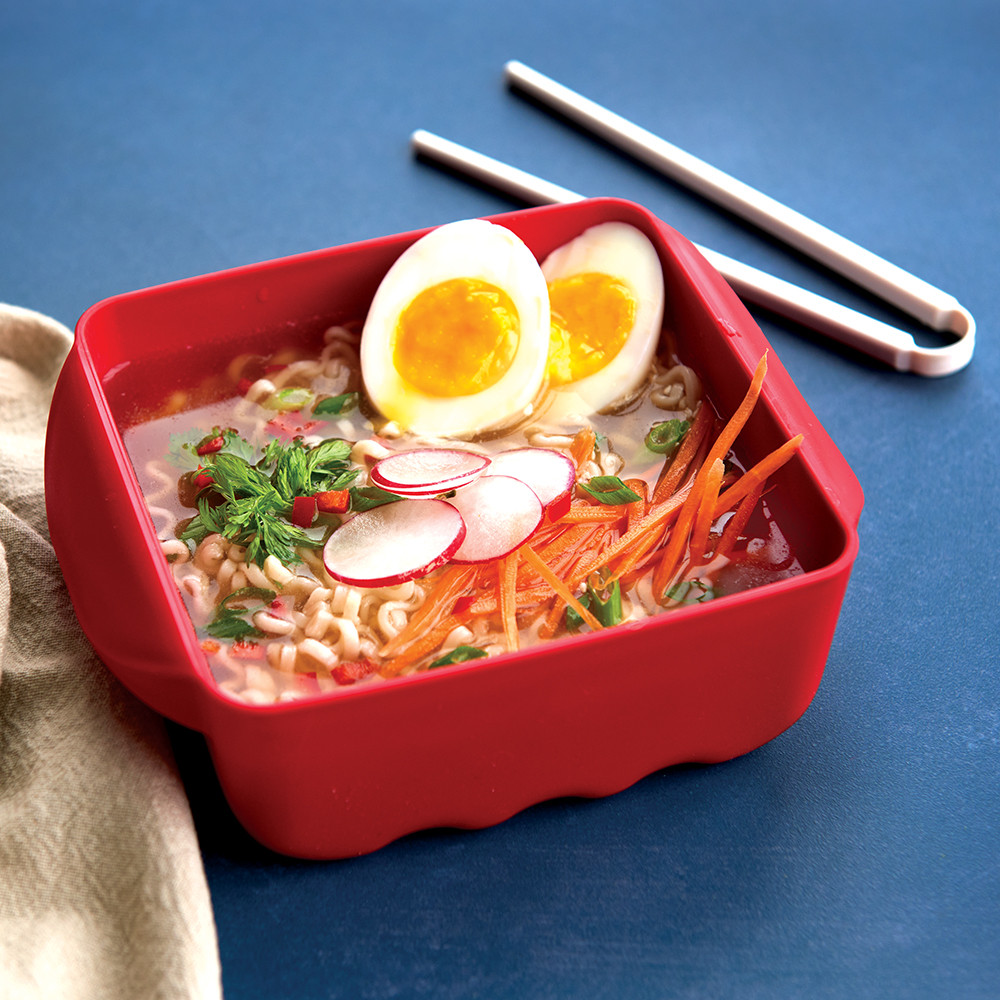 Nordic Ware Ramen Rush bowl with cooked ramen noodles, soft-boiled eggs, and colorful vegetables