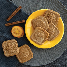 Nordic Ware springerle cookies with detailed fall forest designs on yellow ceramic plate, showing embossed leaf and acorn patterns