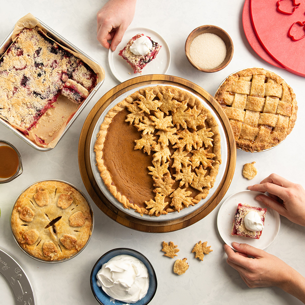 Nordic Ware aluminum pie pans with baked pumpkin pie, mini apple pies, and rectangular pie bars displayed
