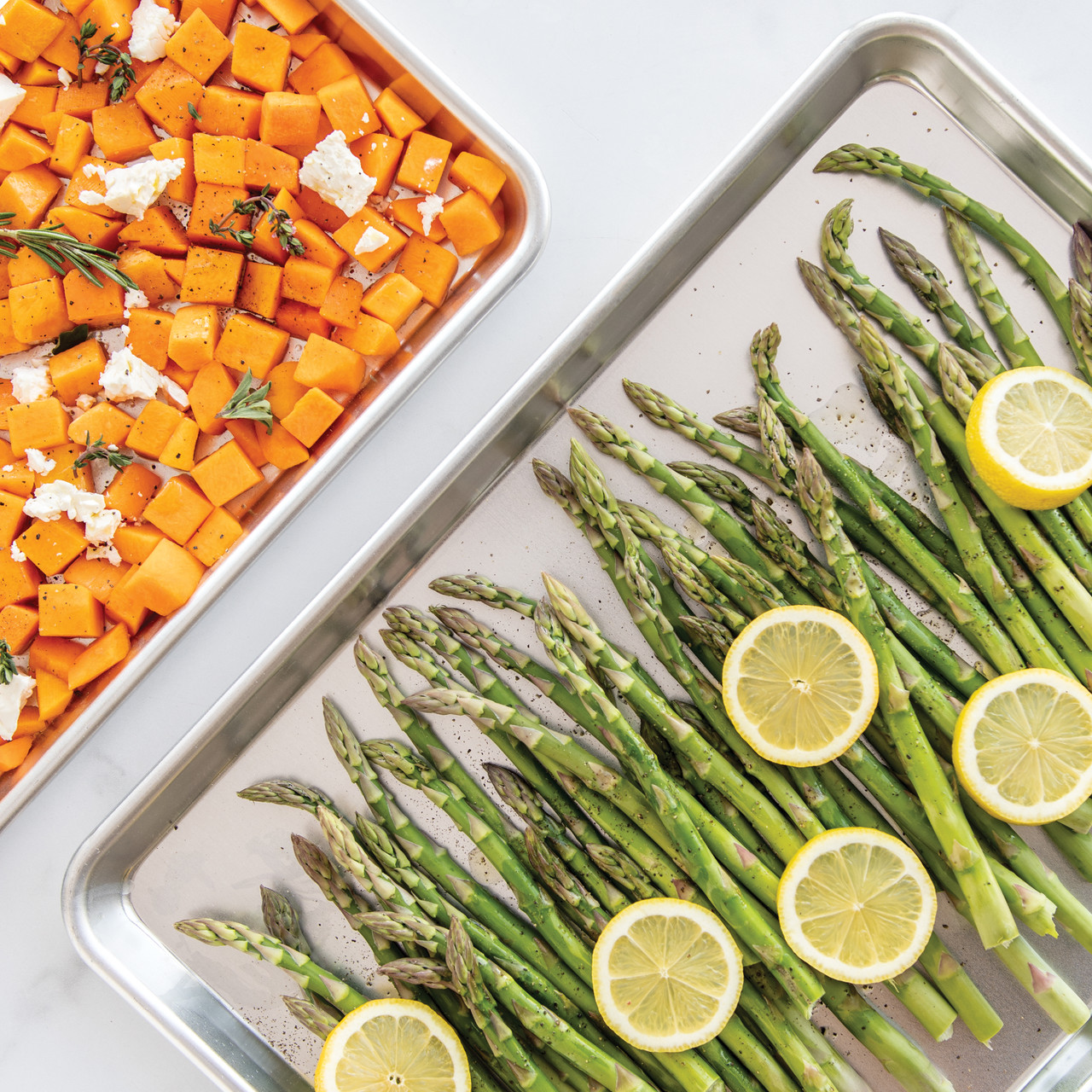 Nordic Ware aluminum half sheet and quarter sheet pans with roasted vegetables, natural silver finish