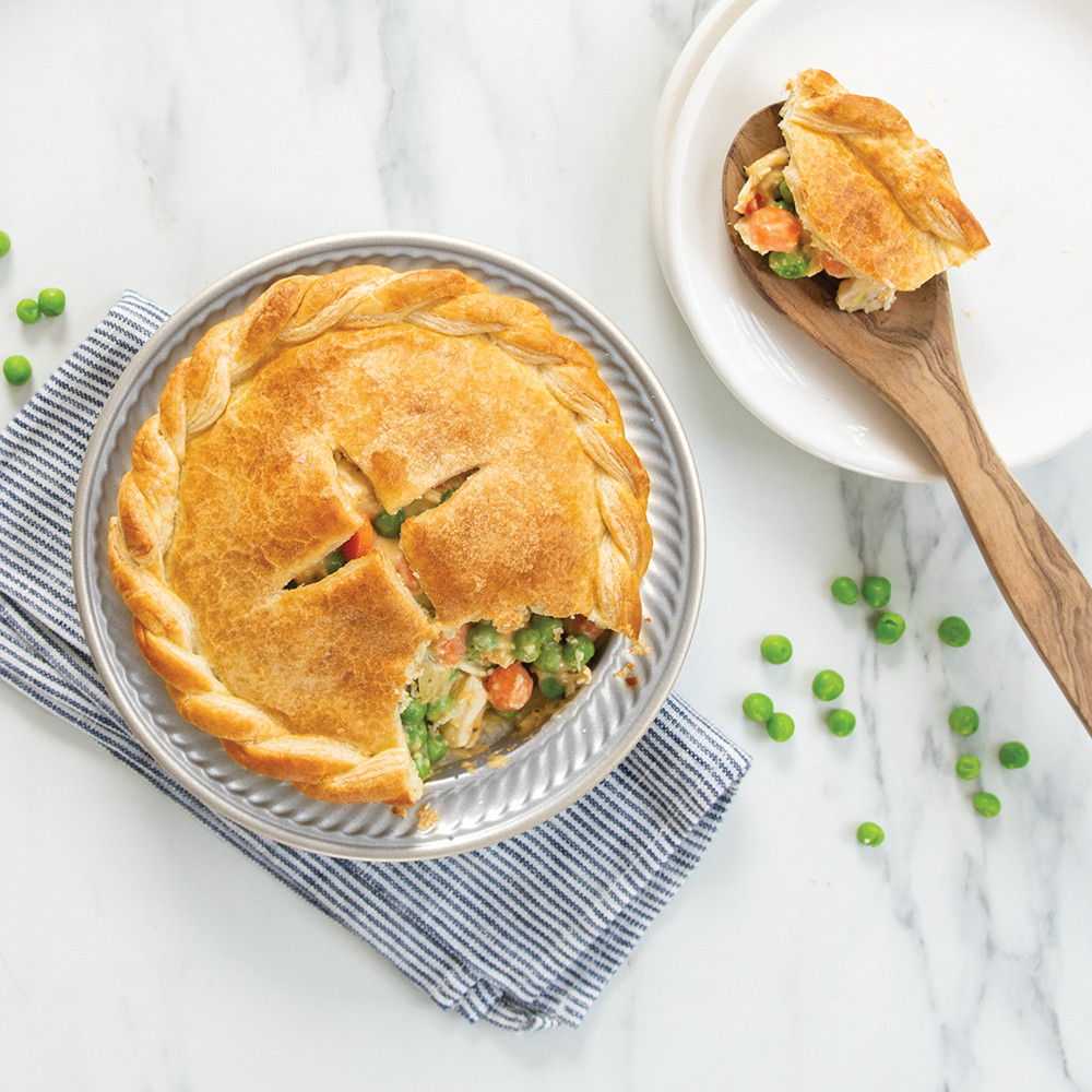 Golden baked chicken pot pie with flaky crust in Nordic Ware 5-inch aluminum mini pie pan
