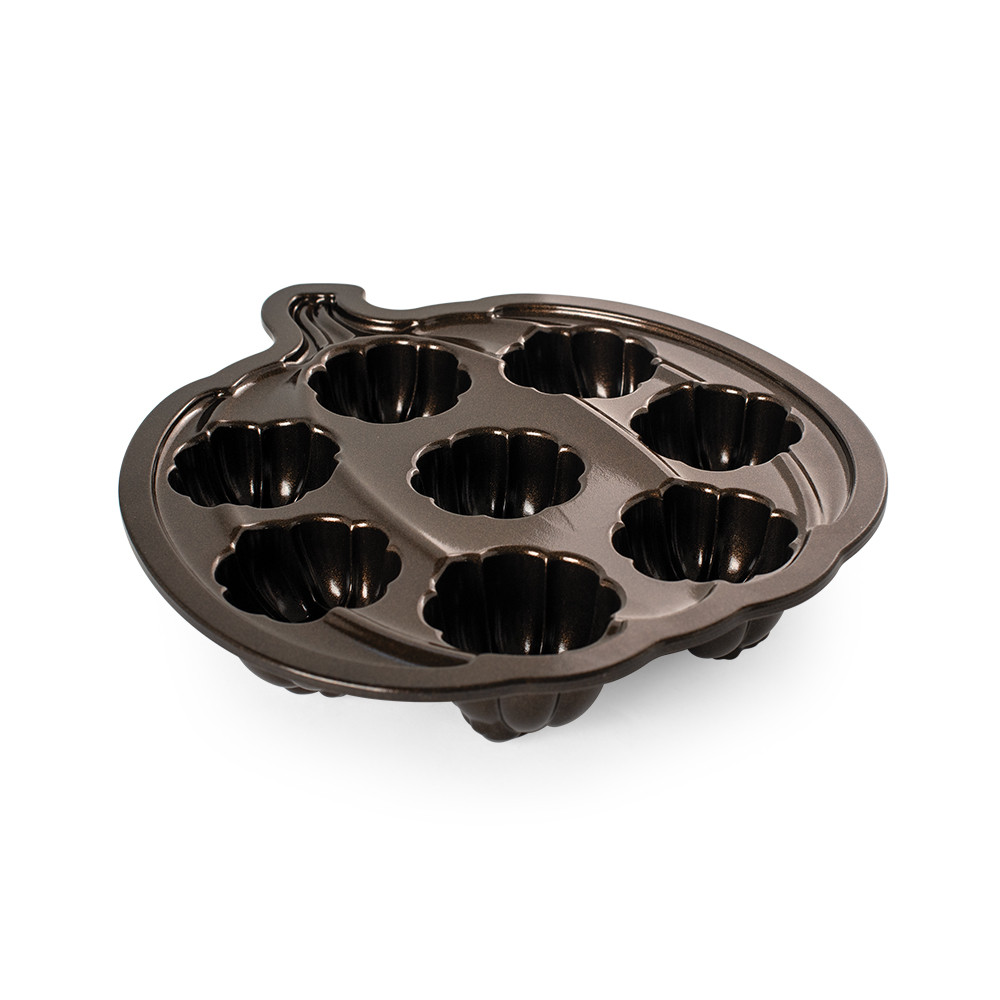 Nordic Ware aluminum Lil' Pumpkin Cakelets pan with 6 pumpkin-shaped cavities, angled view showing interior detail