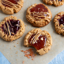 Nordic Ware aluminum half sheet pan with golden-brown peanut butter and jelly cookies on parchment paper