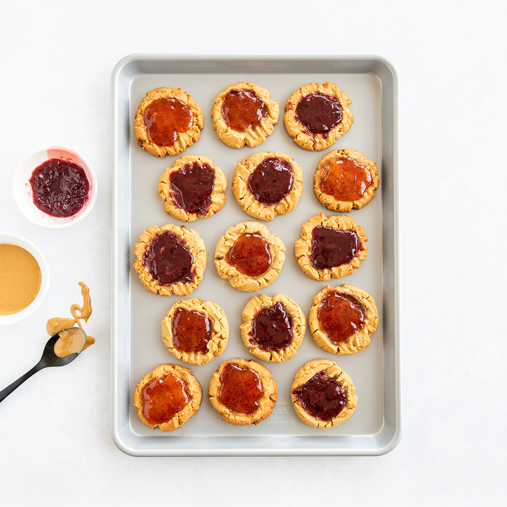 Nordic Ware aluminum half sheet pan with baked peanut butter and jelly cookies, golden brown finish