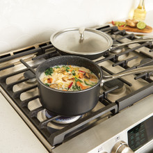 Nordic Ware Basalt dark gray 8" sauté skillet and 3-quart sauce pan with lid on gas stovetop