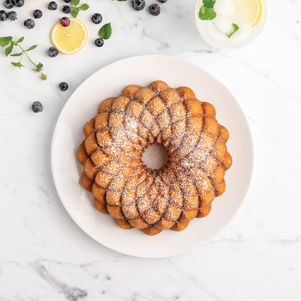 Powdered sugar dusted bundt cake from Nordic Ware Kaleidoscope pan, showing intricate geometric pattern design