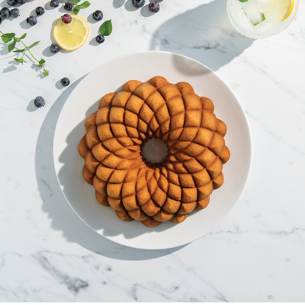 Nordic Ware Kaleidoscope bundt pan with golden baked cake showing intricate geometric pattern design