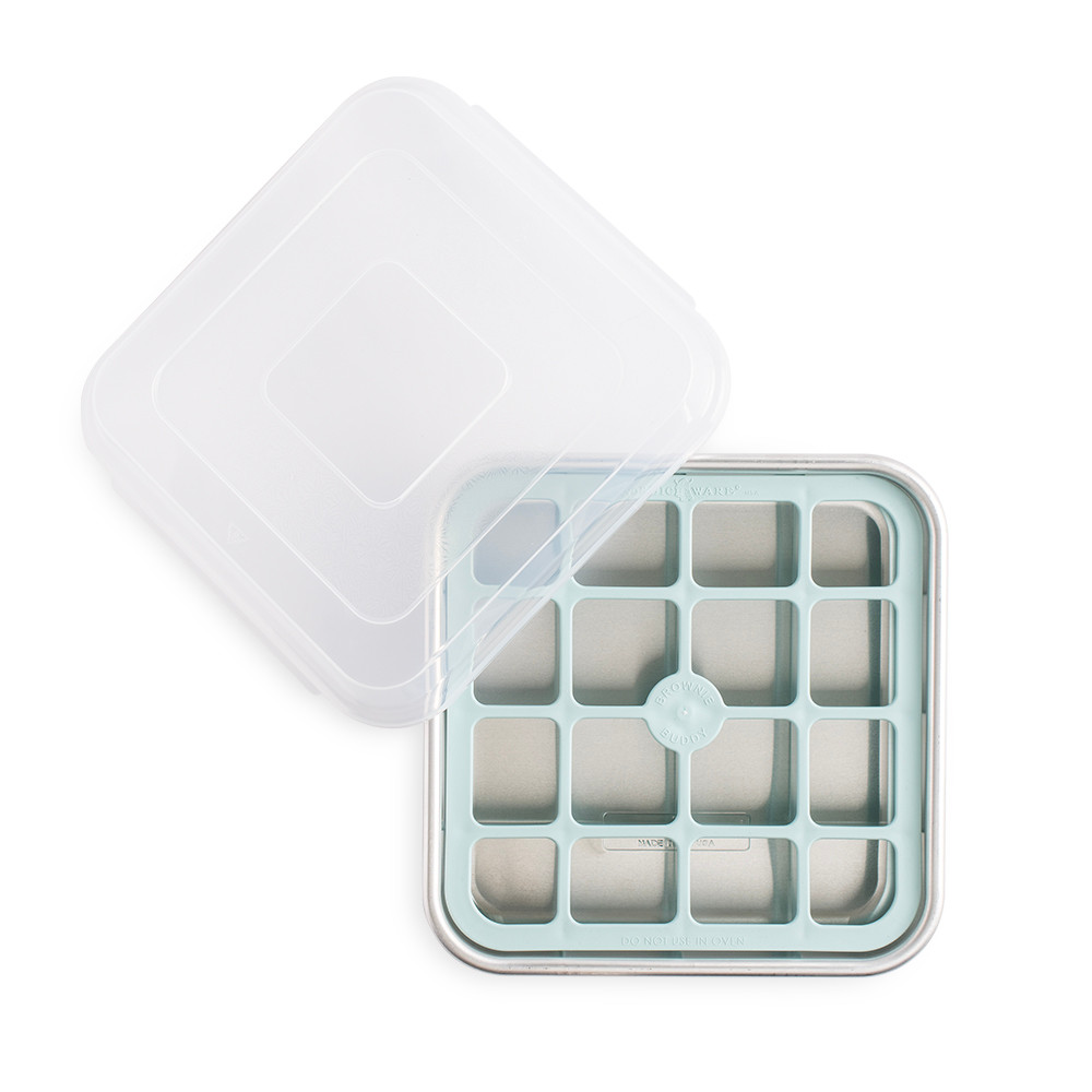 Nordic Ware Brownie Buddy baking set with aluminum pan and plastic cutting grid, overhead view on white background