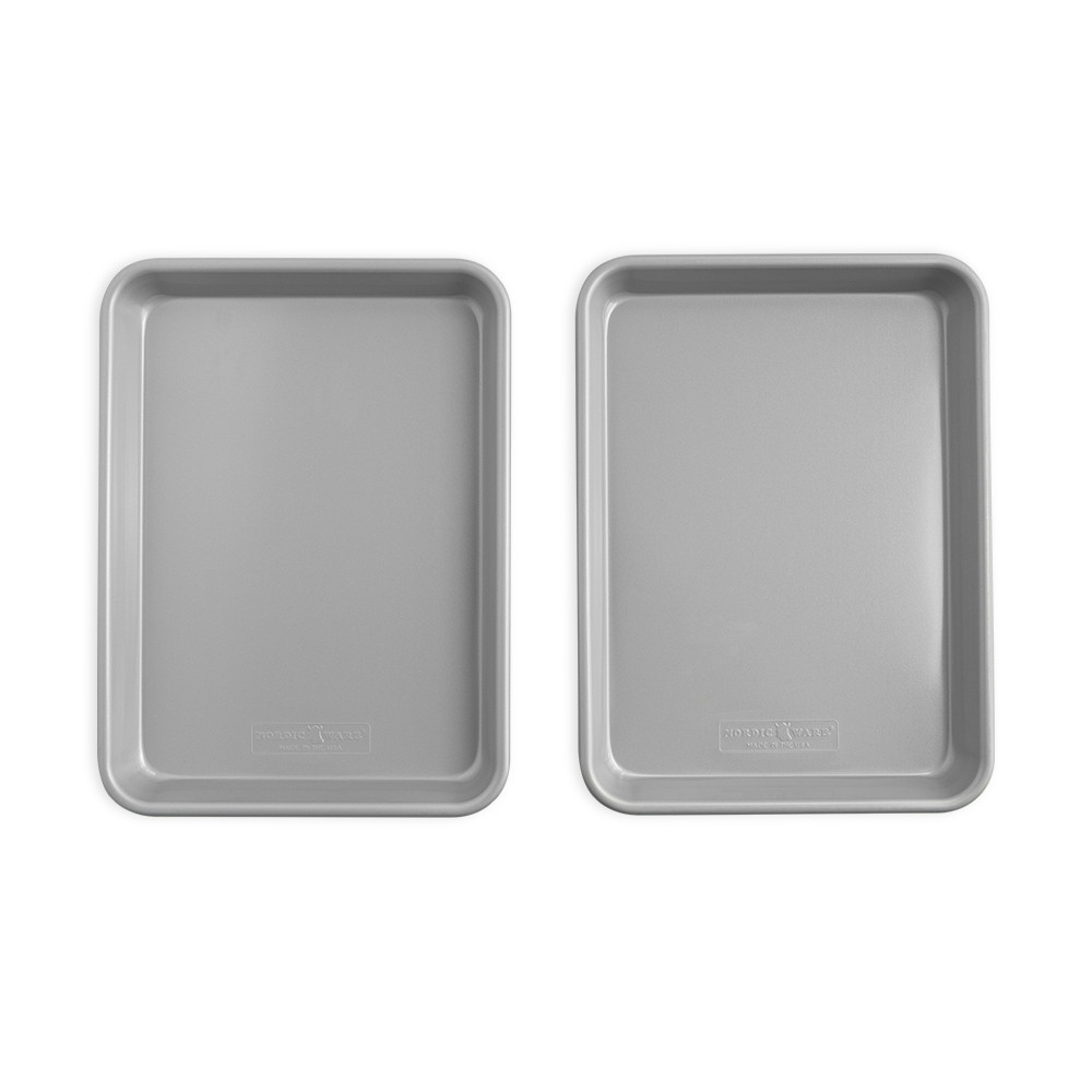 Two Nordic Ware nonstick quarter sheet pans with light colored interior coating, stacked and arranged side by side