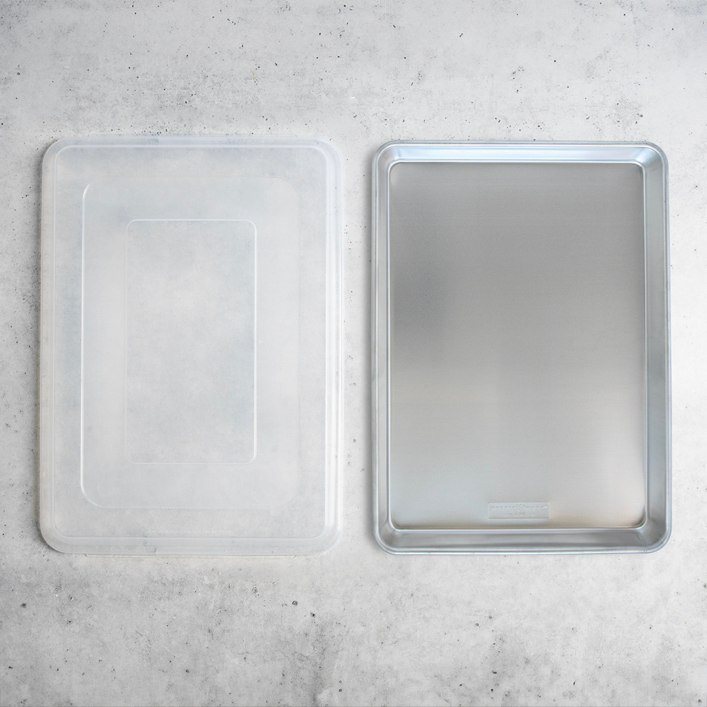 Nordic Ware aluminum Big Batch pan with fitted lid, rectangular natural silver cookware set shown separately