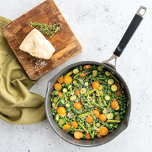 Verde ceramic nonstick skillet with lid containing colorful sautéed vegetables, overhead view showing green handles