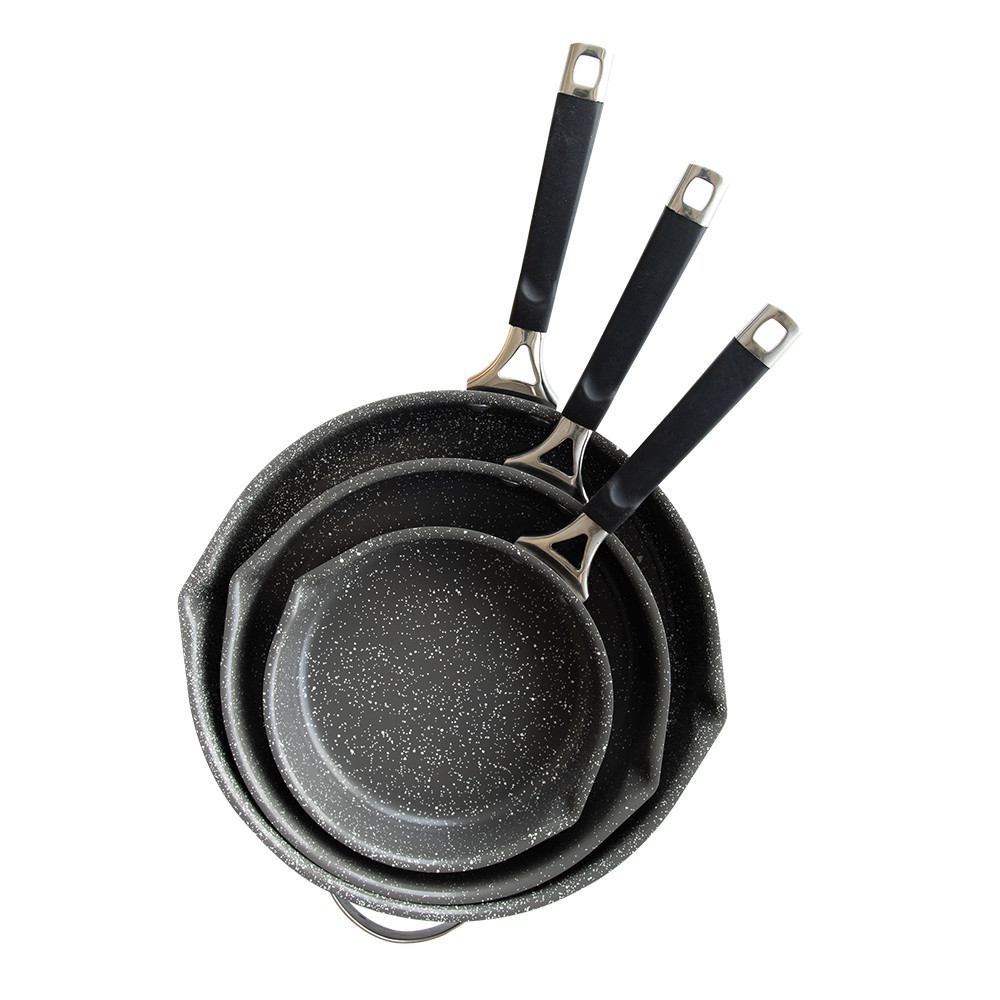 Three Nordic Ware Verde ceramic nonstick skillets in green finish, nested together with glass lid visible