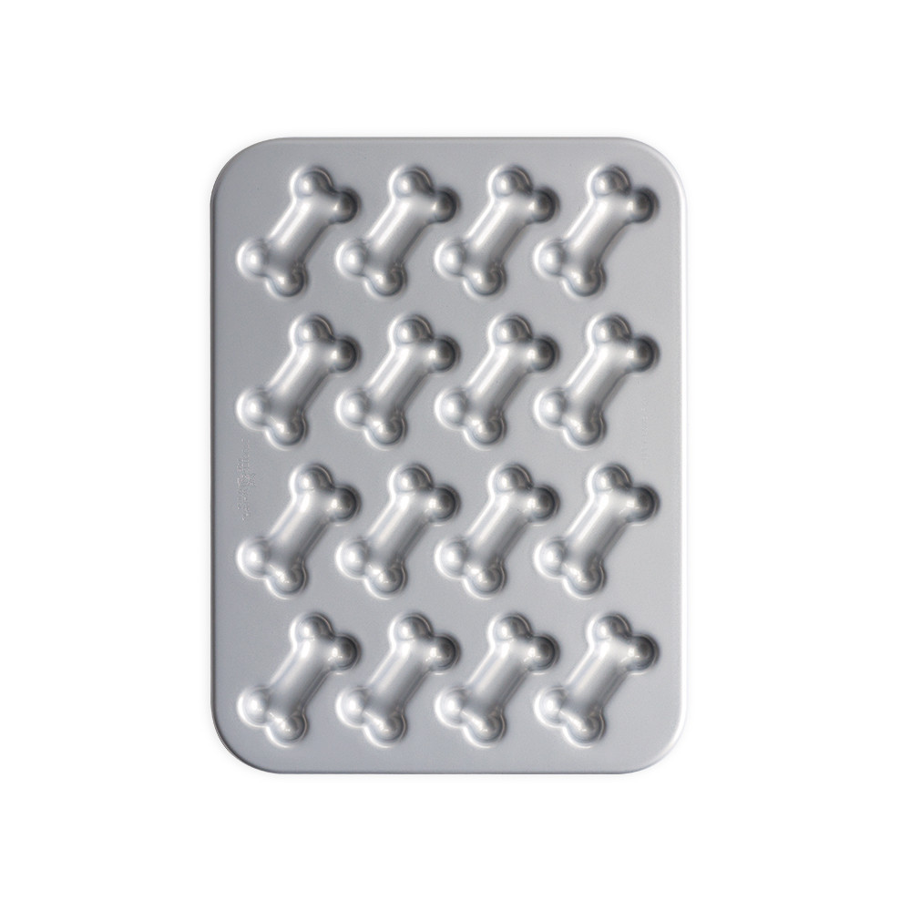 Nordic Ware red nonstick treat pan with 12 bone-shaped cavities, silver interior coating visible