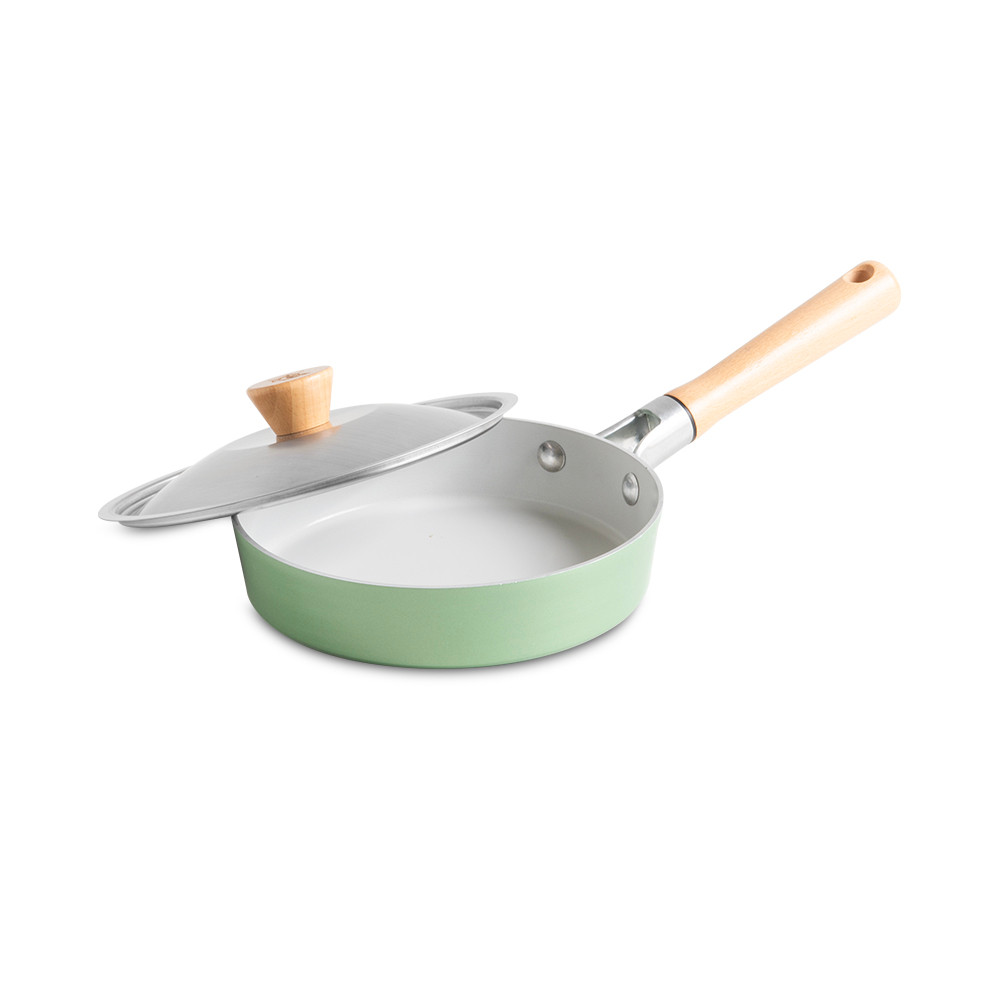 Nordic Ware Cardamom 8-inch nonstick saute pan with glass lid, cream colored exterior, angled view