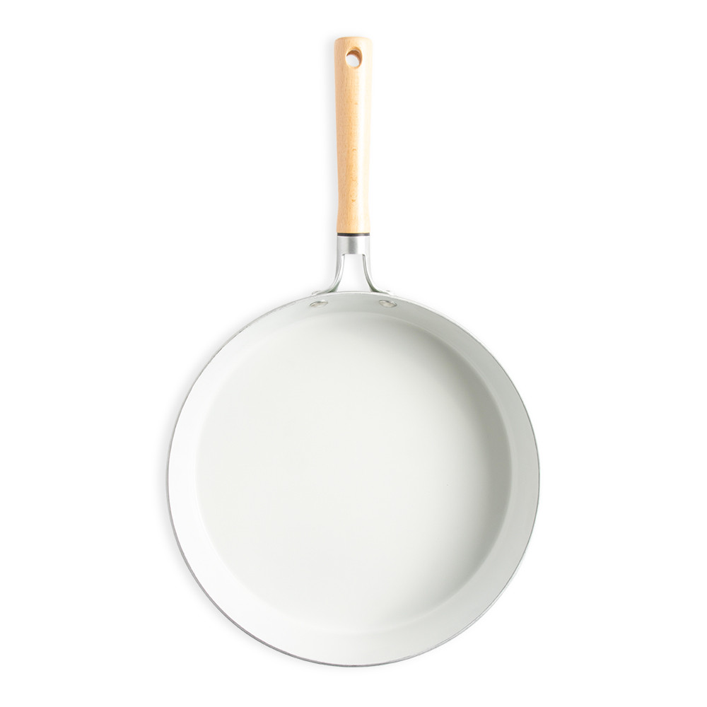 Nordic Ware Cardamom 12-inch skillet interior view, ceramic nonstick coating in cream color with dark rim