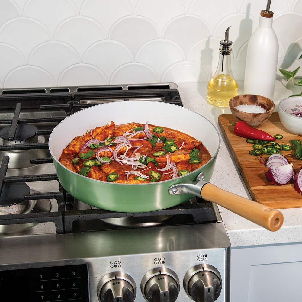 Nordic Ware cardamom ceramic nonstick 12-inch skillet with sautéed onions and peppers in golden sauce