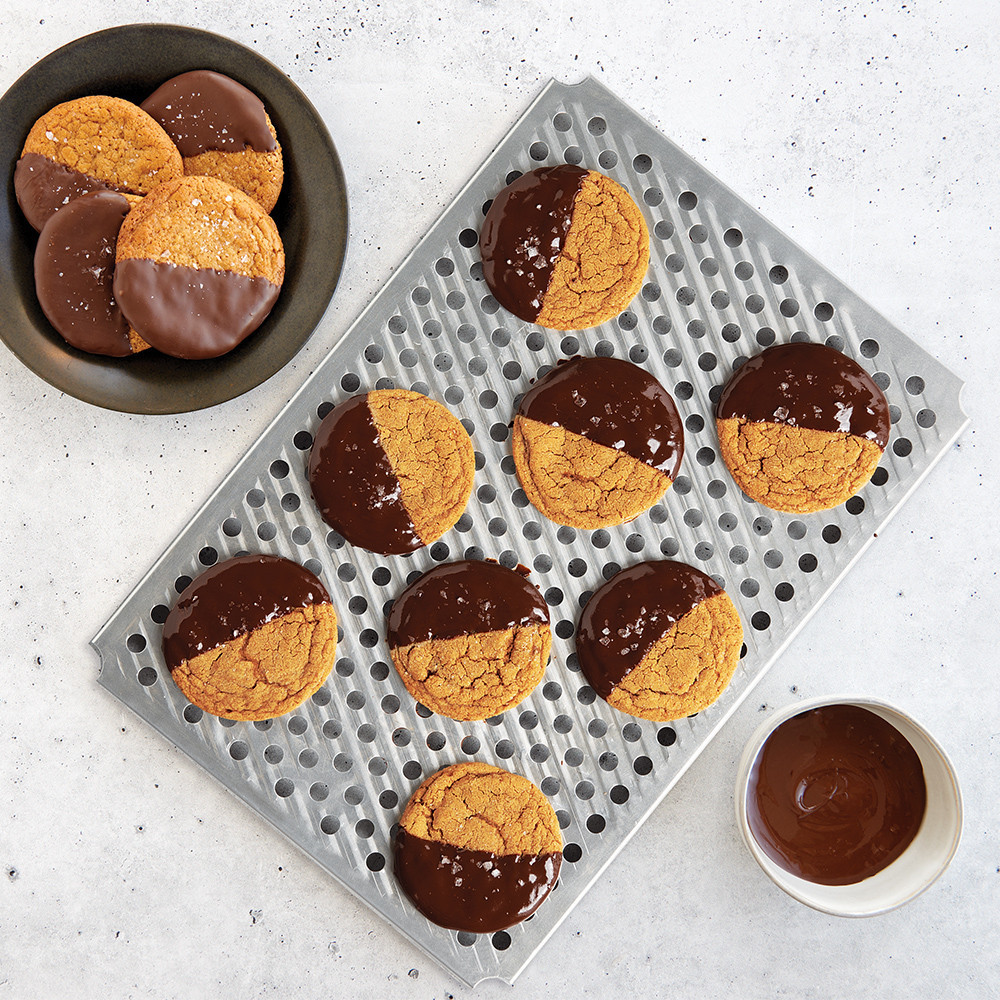 Wire cooling rack with chocolate-dipped cookies on Nordic Ware aluminum half sheet pan, natural finish