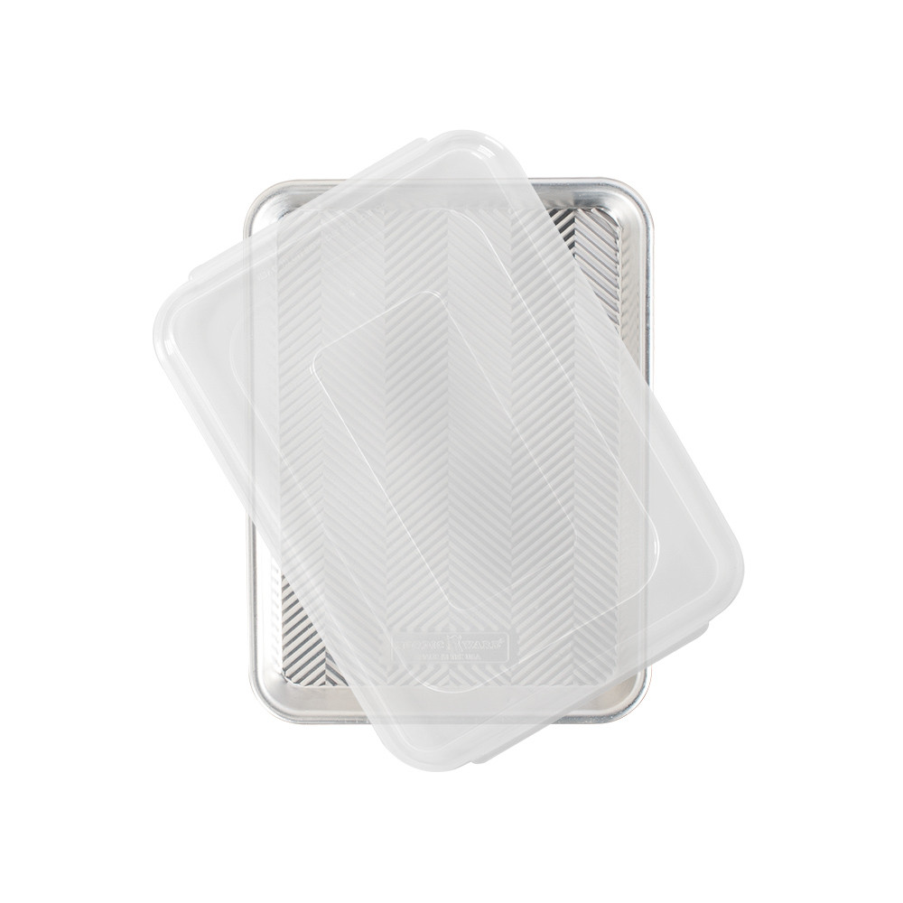 Nordic Ware aluminum quarter sheet baking pan with clear plastic lid, natural silver finish, overhead view