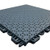 Close-up of a gray interlocking sports court tile with a perforated, textured surface designed for outdoor athletic flooring and efficient water drainage.