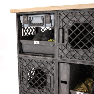 Close-up of a CrateShot Bench storage bay with a gray Grab Bin, rope, soft gear, and MOD panel storage.