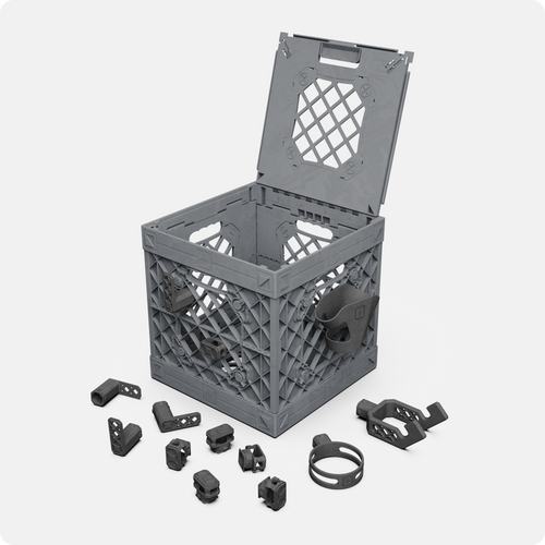 Gray UbeCube BenchBox UC01 crate with plier holders, hooks, drill holder, and cup holder attachments for organized workbench storage.