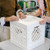 White UC01™ collapsible crate being handled on a tabletop to show the sturdy stackable crate design