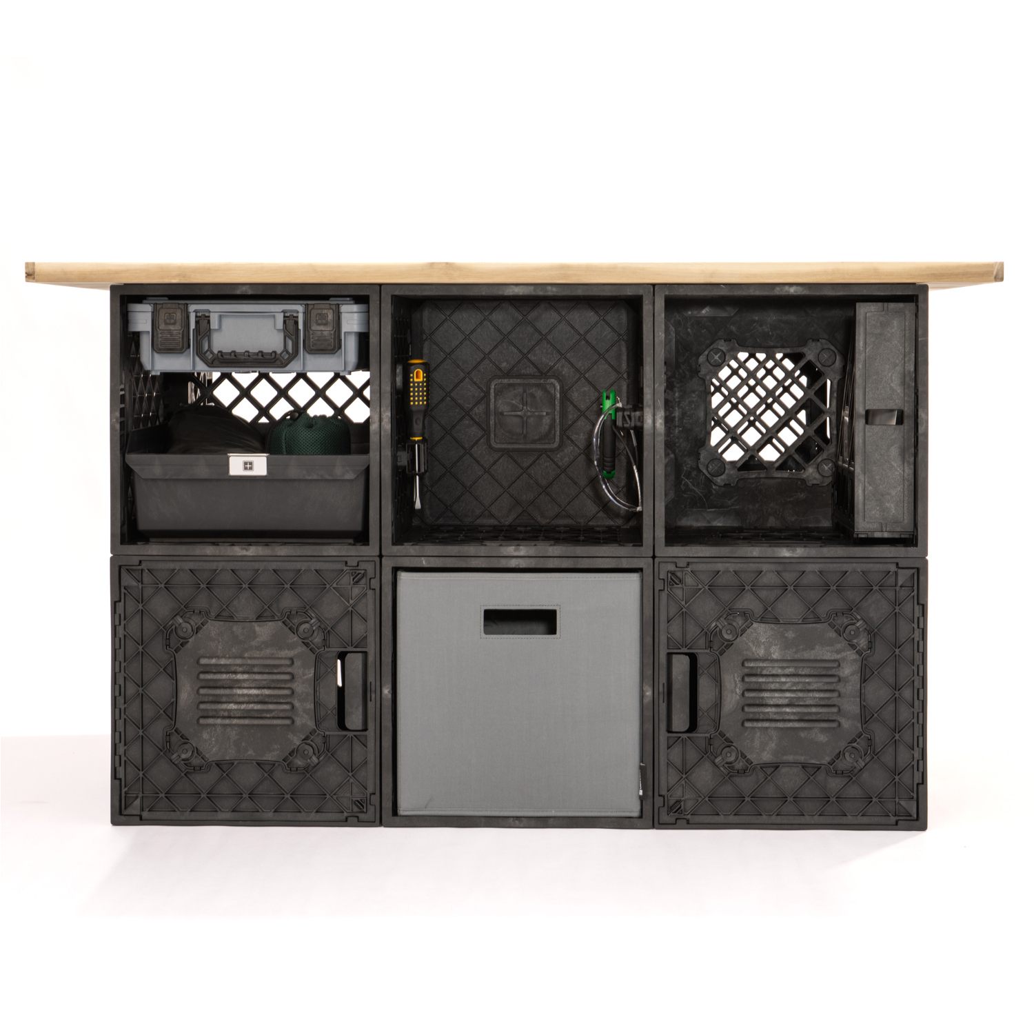 Front view of a CrateShot Bench built from black UbeCube crates with MOD panels, internal storage, and a wood work surface.