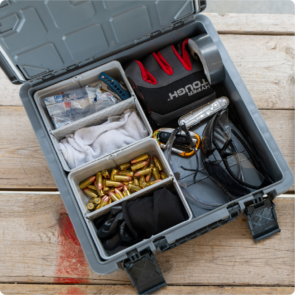 Open gray BaseBox organized with ammunition, gloves, safety glasses, medical supplies, and range gear.