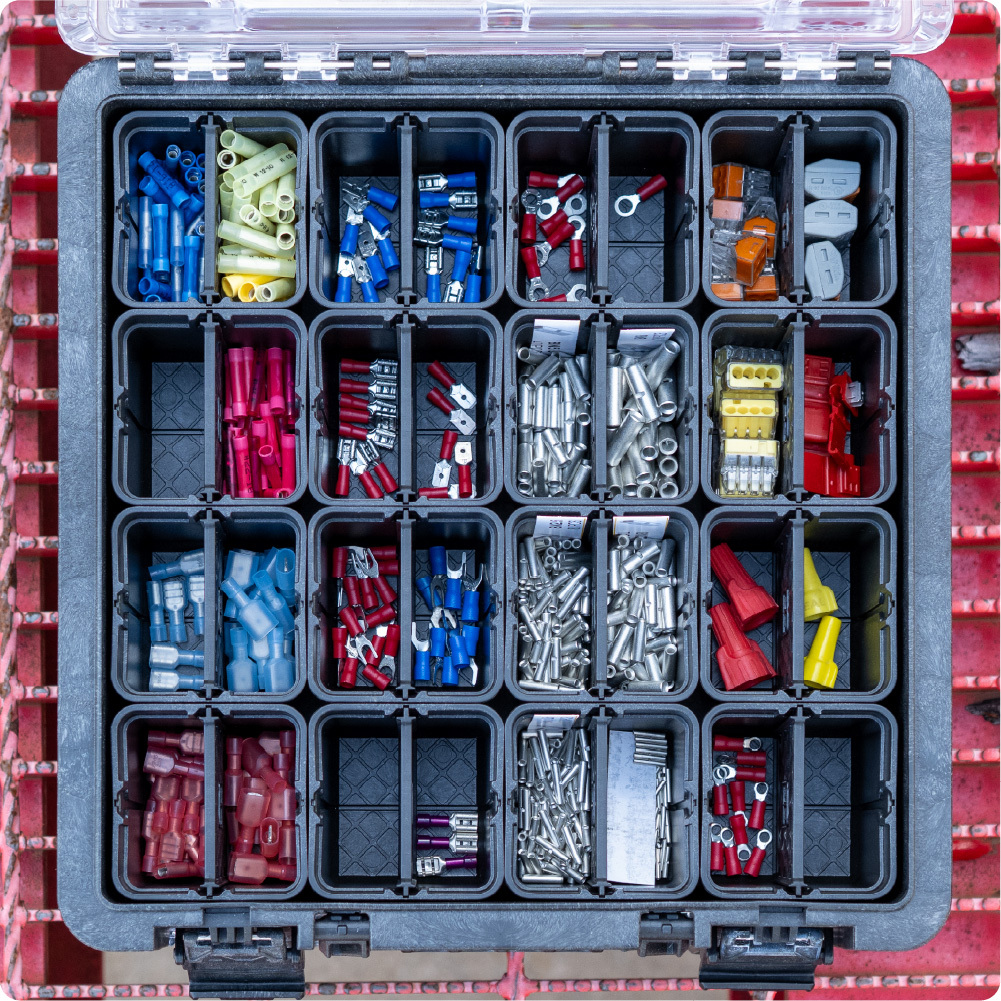 Open black BaseBox with divided compartments organizing electrical connectors, screws, fasteners, and small hardware.