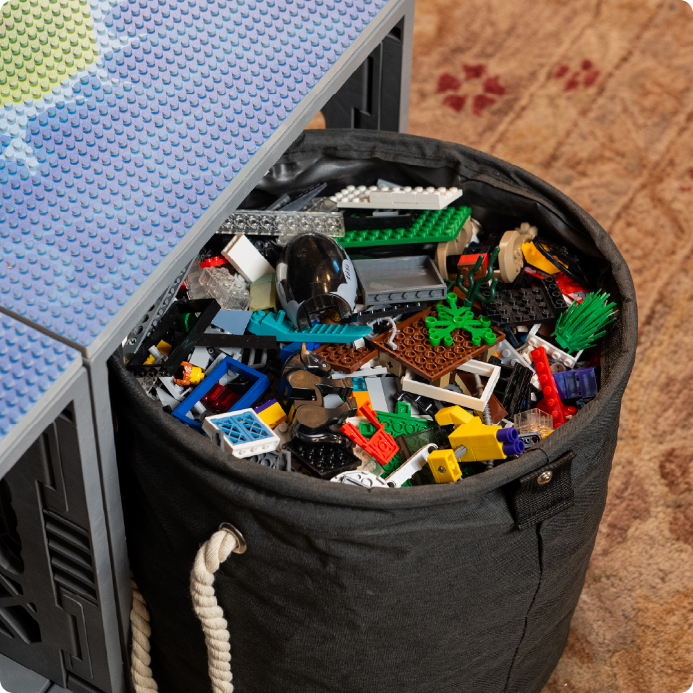 CratePlay toy storage bag filled with LEGO-compatible bricks beside a gray UbeCube crate with a build plate.