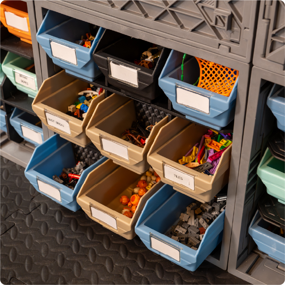 CratePlay storage wall with labeled Grab Bins organizing LEGO-compatible bricks, tiles, and small toy pieces inside gray UbeCube crates