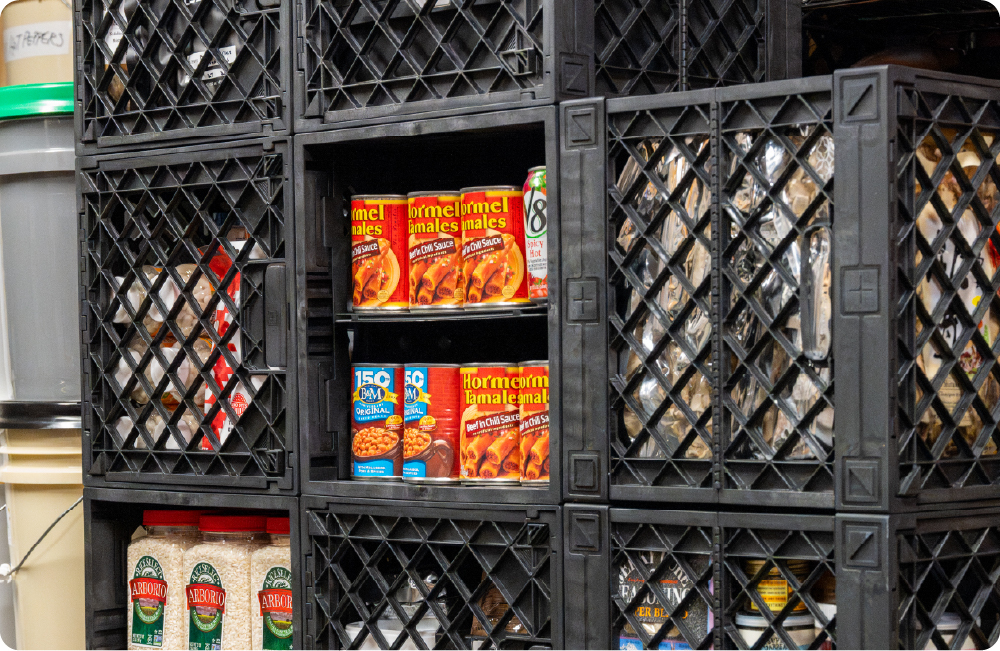 Black UbeCube pantry storage wall organized with canned food, rice, dry goods, and shelf-divided crates.