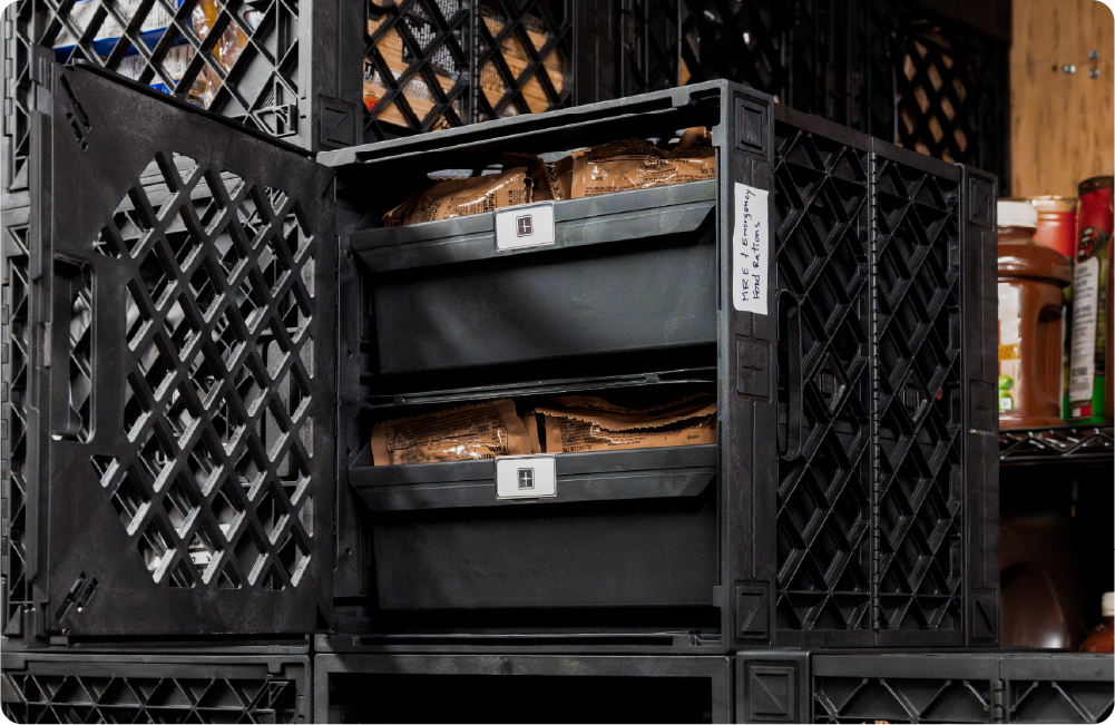 Black UbeCube pantry crate with Grab Bins and shelf kits organizing packaged emergency food rations.