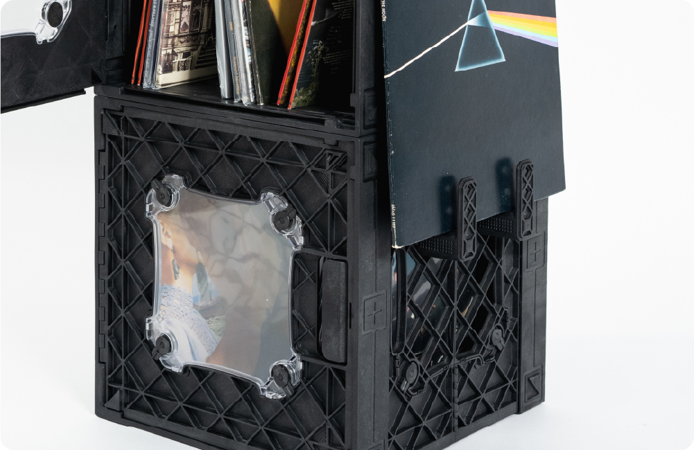 Black UbeCube CrateVinyl tower with records stored inside, a clear display panel, and albums displayed on side-mounted CrateHooks.