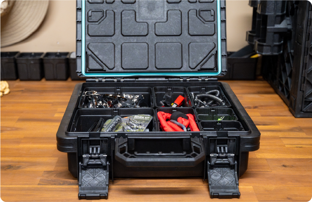 Open BaseBox tackle box organized with fishing tools, hooks, pliers, and small gear compartments.