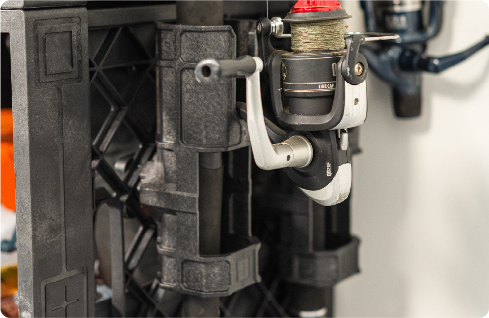 Close-up of a fishing rod secured in a side-mounted UbeCube fishing pole holder.