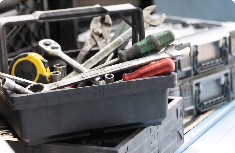 UbeCube Drop-In Tray filled with garage tools including wrenches, screwdrivers, sockets, pliers, and a tape measure.