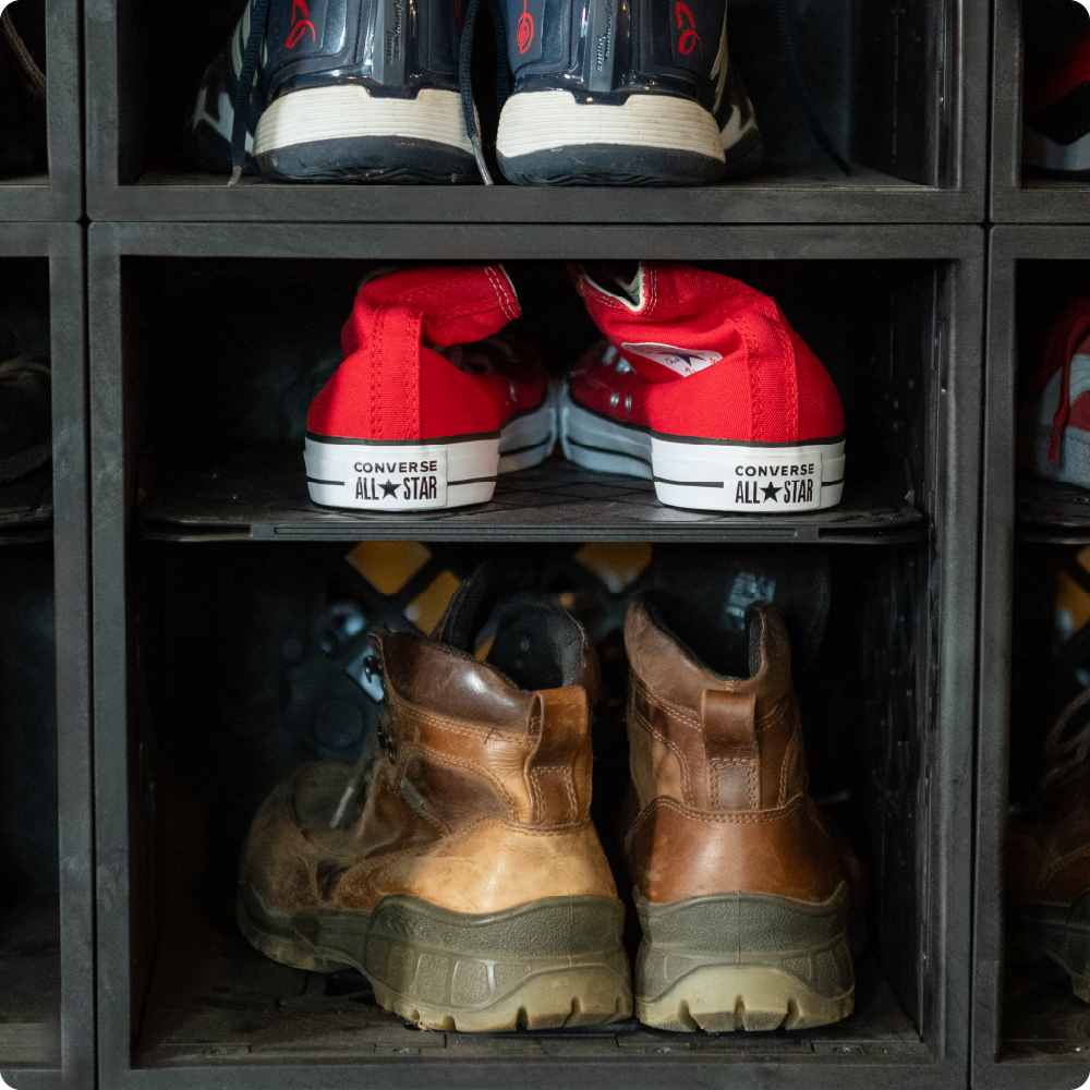Black UbeCube shoe storage setup with CrateDividers creating separate shelves for sneakers and work boots.