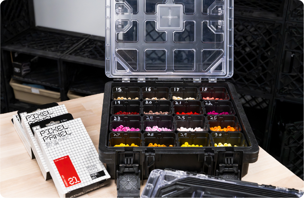 Open BaseBox™ used as a Pixel Panel storage case with sorted colored studs.
