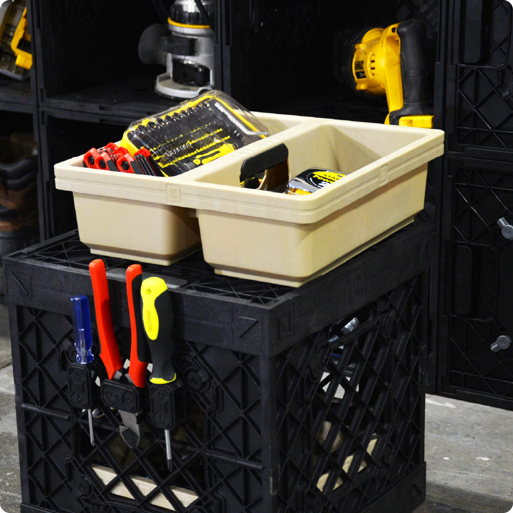 Black UbeCube workshop setup with a Tradesman tray holding tools on top and screwdrivers stored in side-mounted Plier Holders.