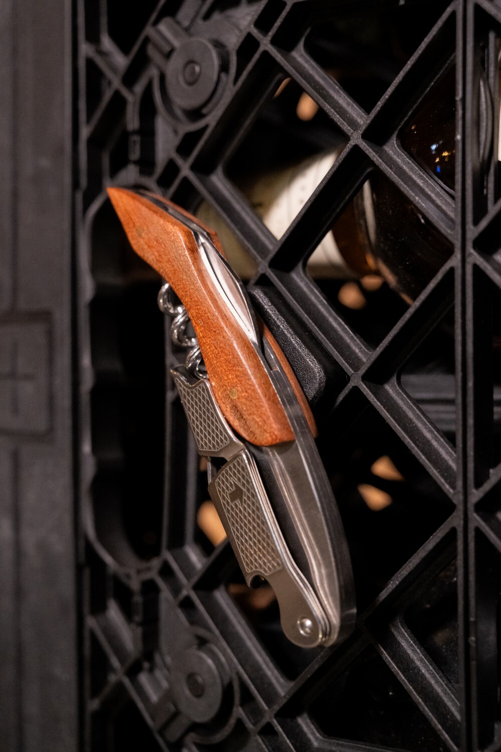 Magnet Clip attached to UC01 Crate holding a wine opener with a wooden handle
