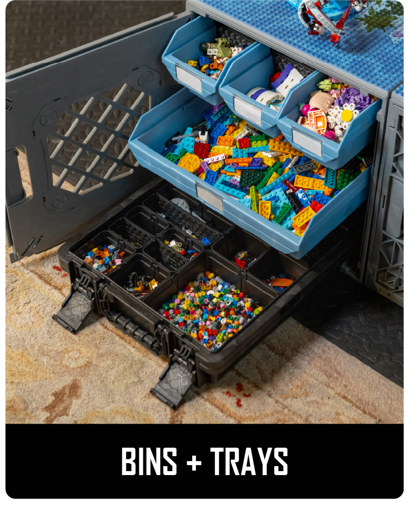 CratePlay™ toy storage setup with blue bins, black trays, and loose building bricks under a play surface.